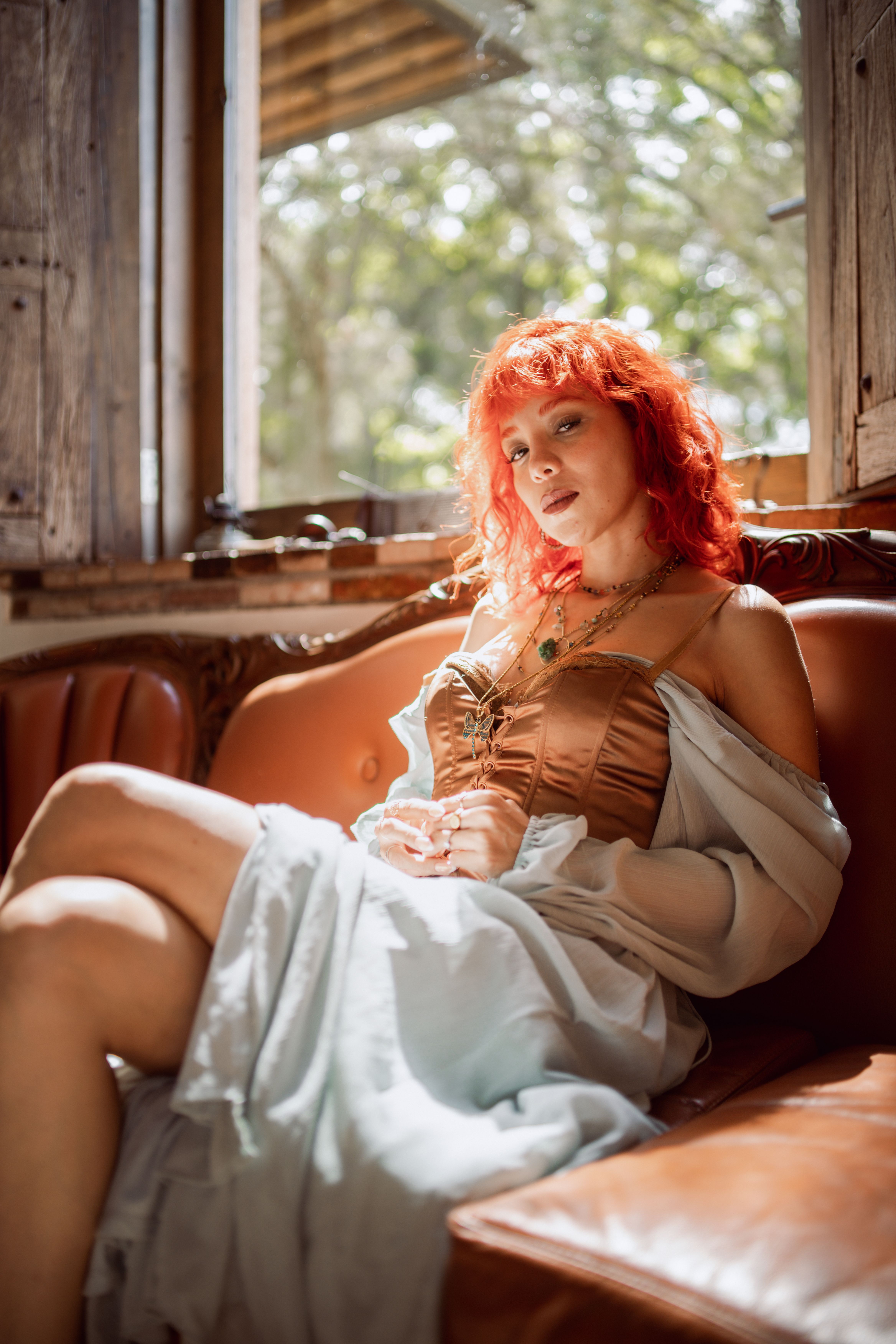 Redhead Woman in Dress on Couch  Free Stock Photo