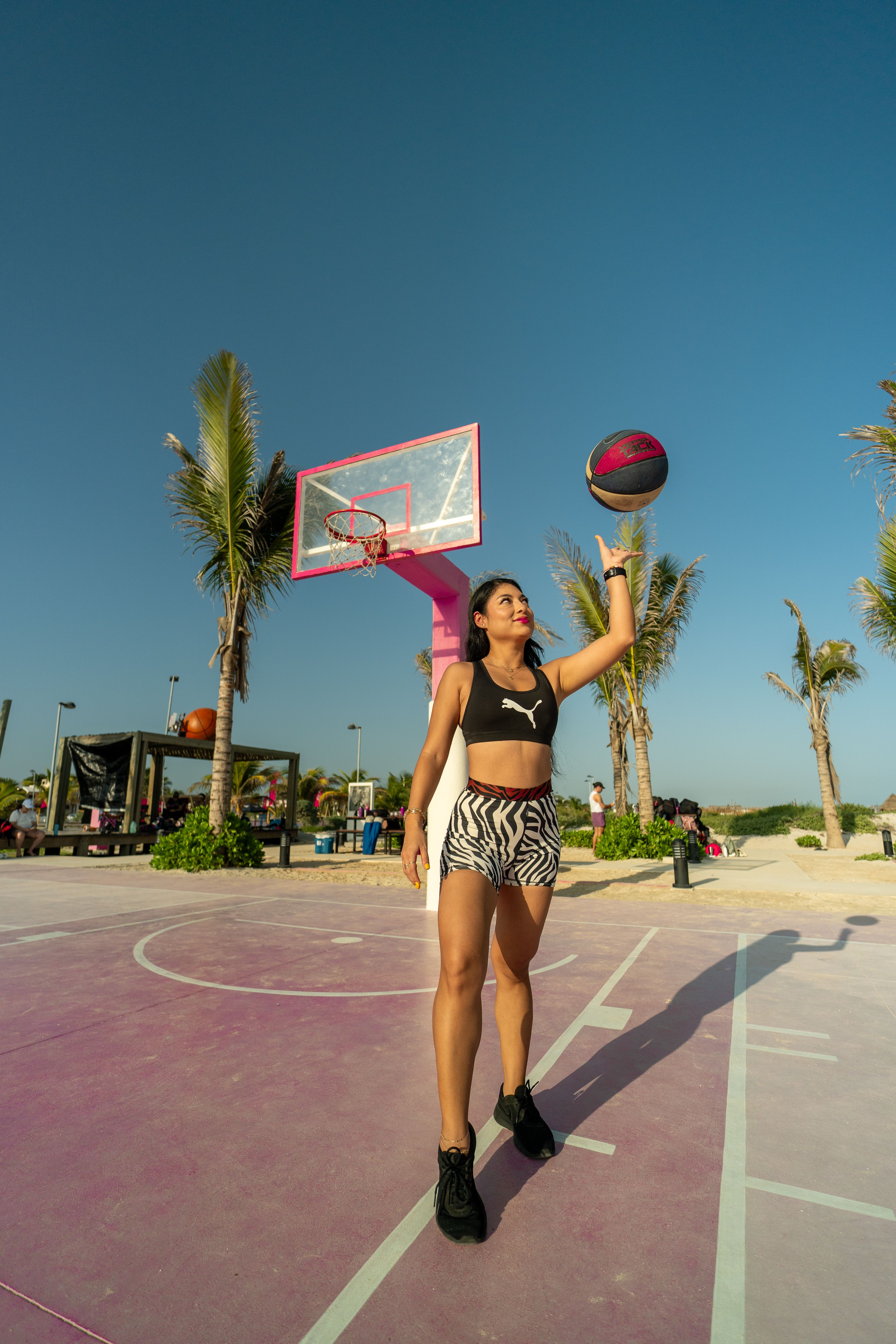 a-woman-in-a-bikini-holding-a-basketball-free-stock-photo