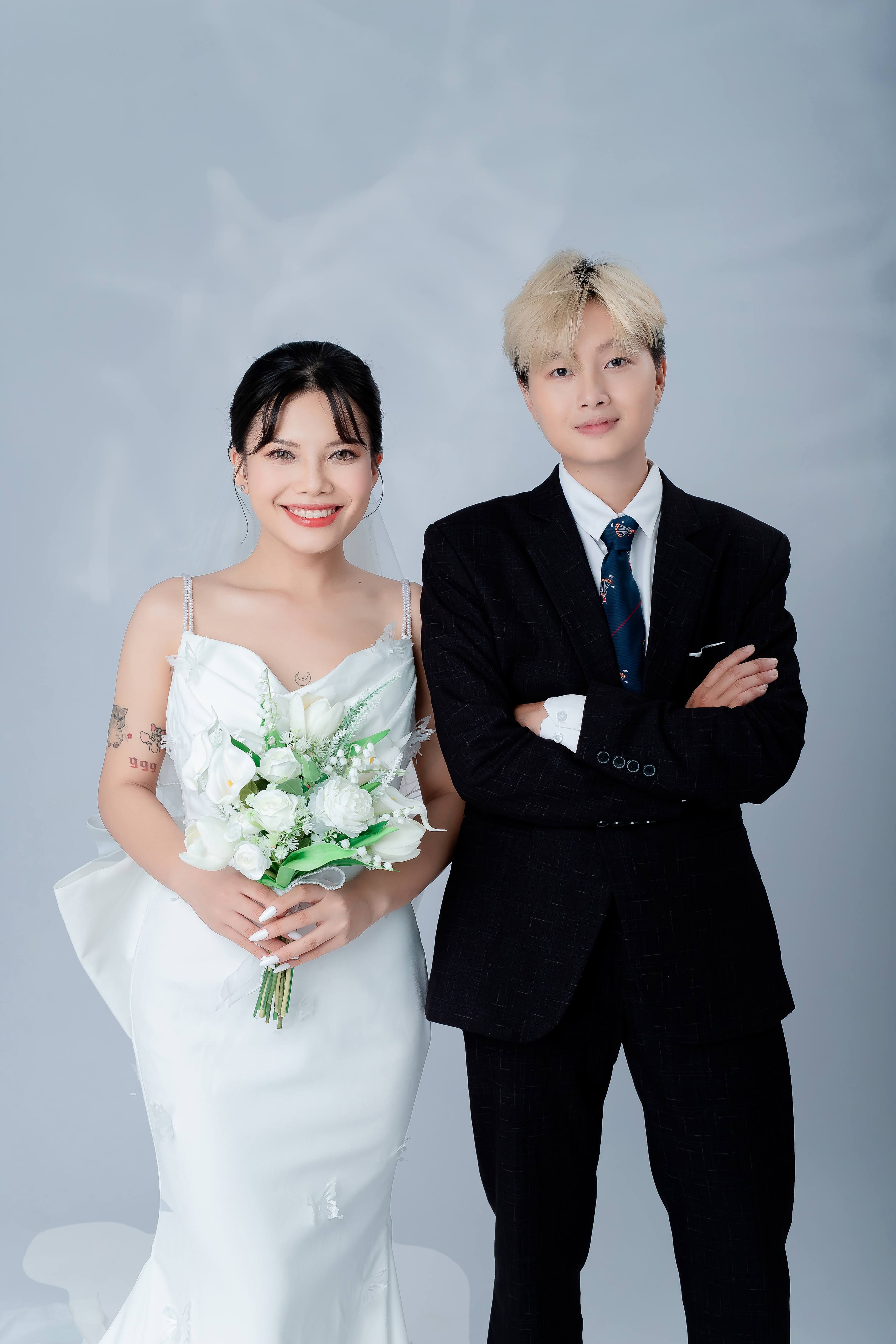 A bride and groom elegantly pose together celebrating their wedding day.