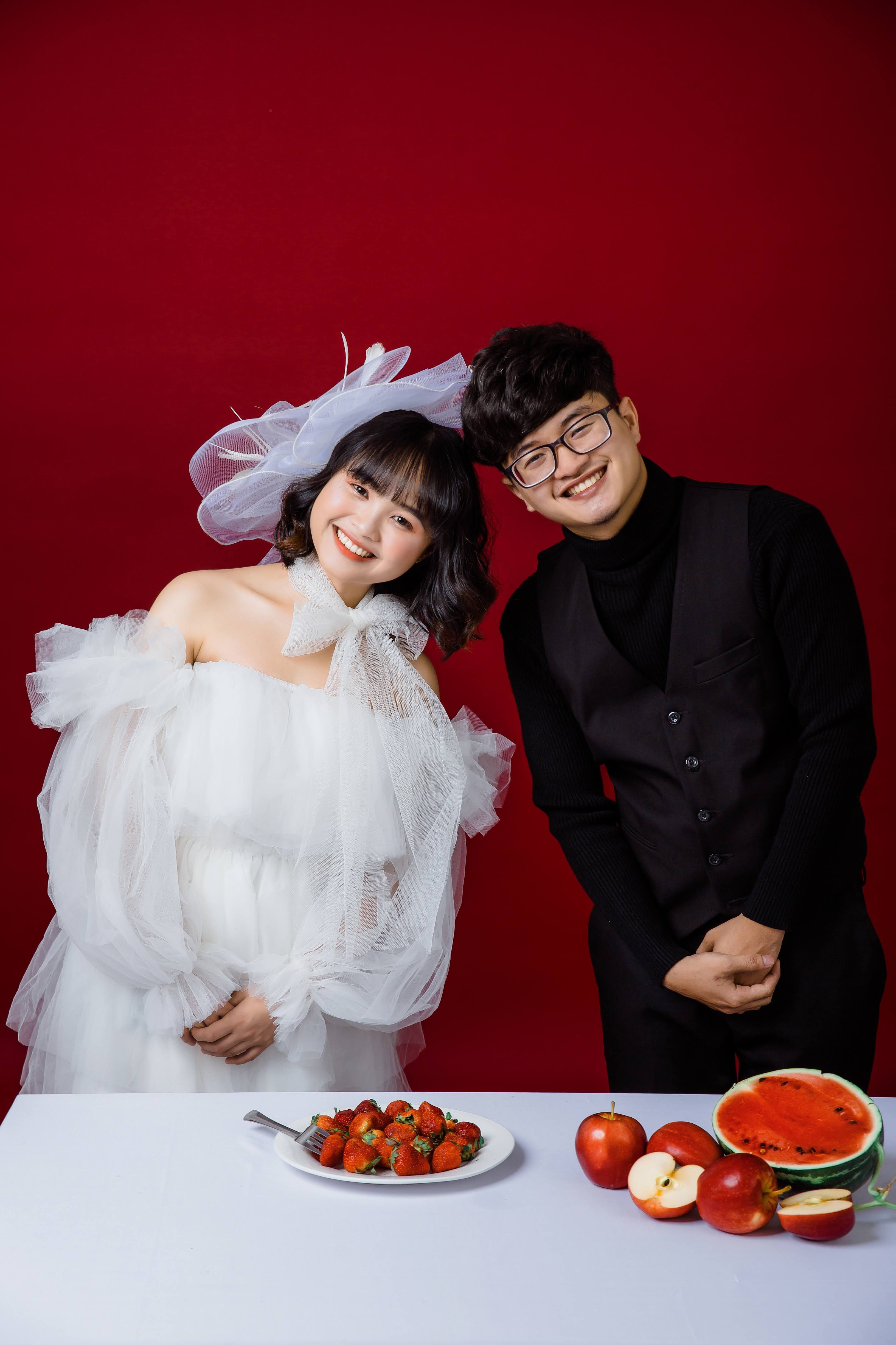 Free A joyful couple celebrating indoors with fresh fruits, embodying love and happiness. Stock Photo