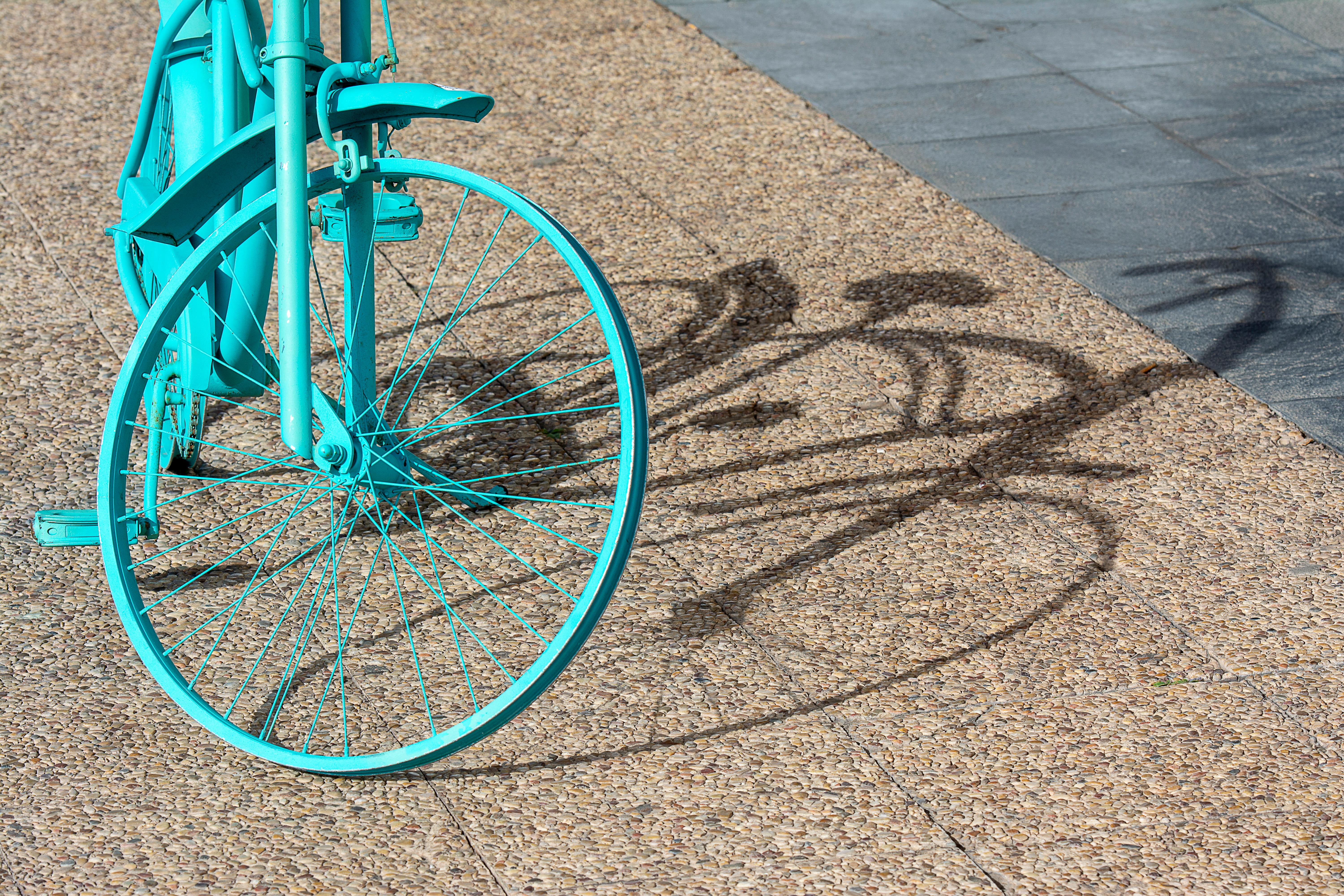 a blue bicycle is parked on the sidewalk