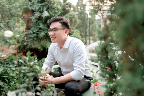 Free Young man in a garden setting, enjoying a moment of relaxation outdoors. Stock Photo