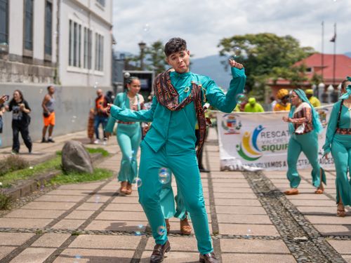 Free Joyful dancers in vibrant costumes celebrating at a street parade in San José, Costa Rica. Stock Photo
