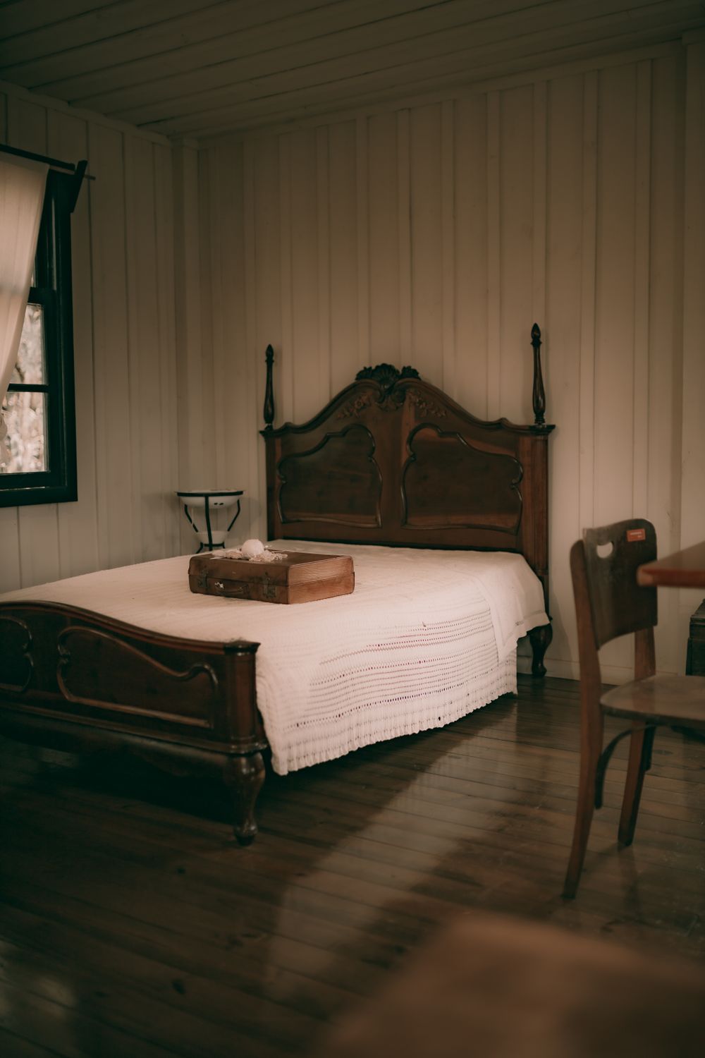 Vintage bedroom with wooden floors and daylight