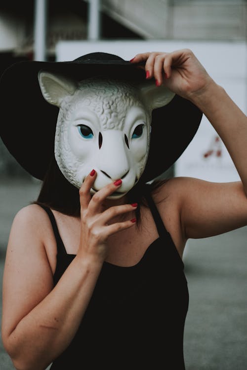 Free Woman Wearing Black Spaghetti Strap Top and White Sheep Mask Standing Stock Photo