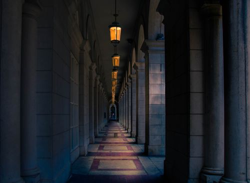 Free A dramatic hallway with columns and arches in Toronto, Canada, showcasing classic architecture. Stock Photo