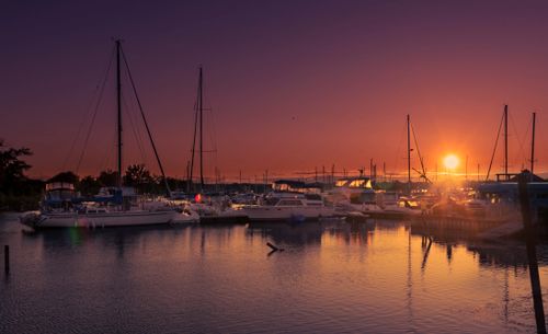 Free Sunset over the marina in Toronto, Canada, featuring sailboats and a calm reflection on the water. Stock Photo