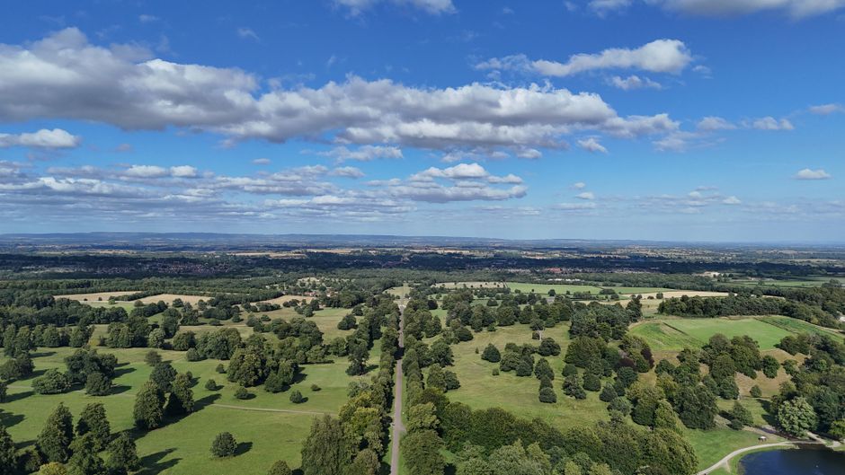 Incredible 25 Minute Royal Surrey Helicopter Tour Review: A Majestic Flight Over England's Finest Countryside Review 2026 - Aerial view of lush green landscapes in North Yorkshire, highlighting fields, trees, and blue skies.