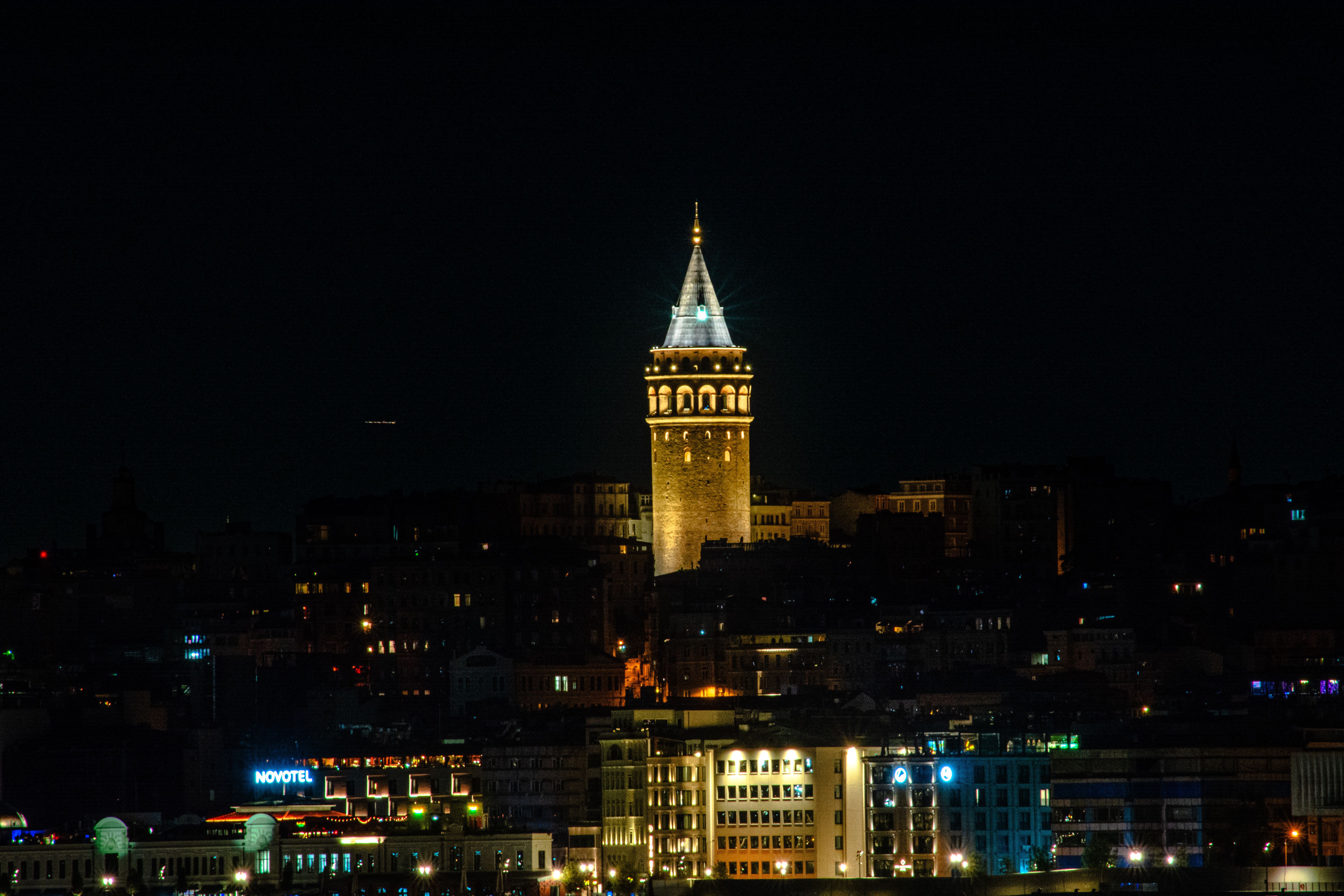Stunning nighttime shot of the historic Galata Tower illuminated against the İstanbul skyline.