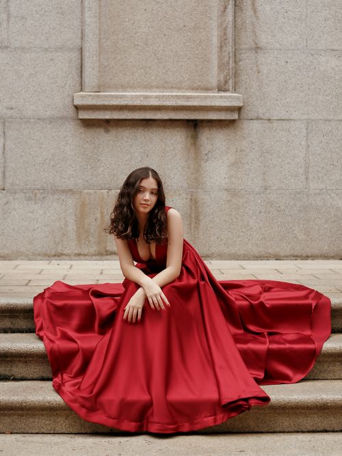 A Young Brunette in a Red Dress Posing on the Stairs · Free Stock Photo