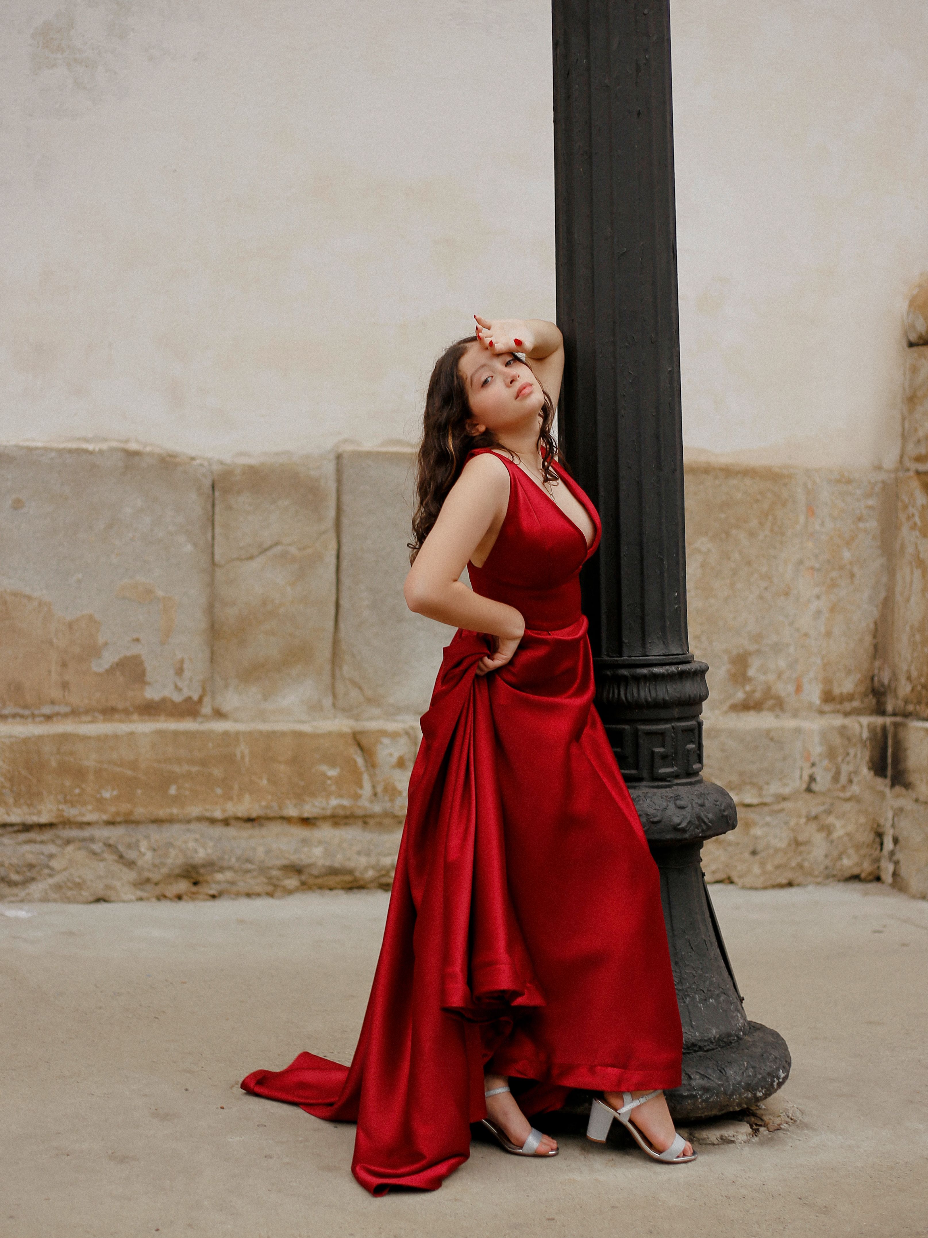 Elegant woman in red dress walking in park  Free Stock Photo