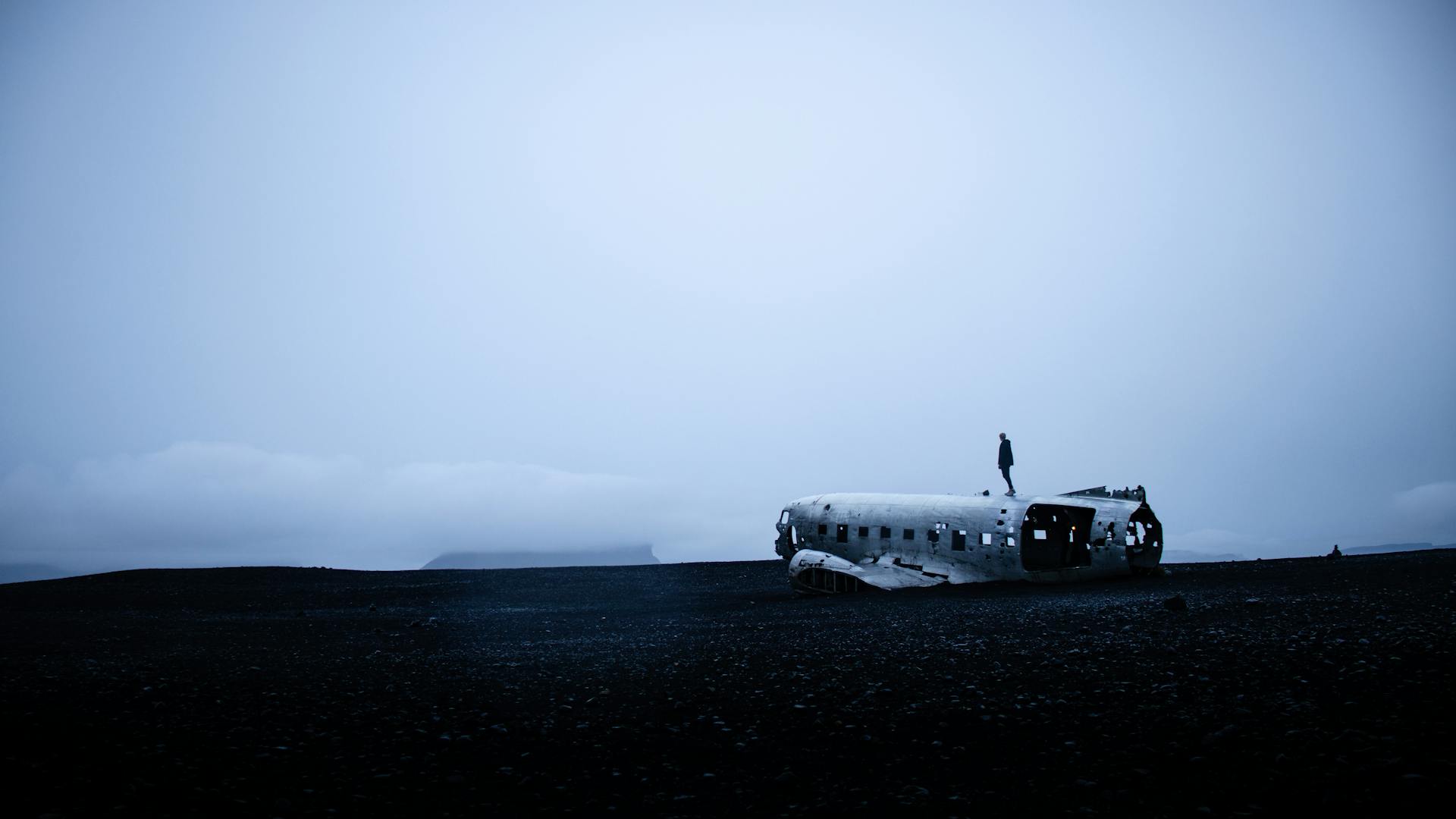 Photo of Person Standing On Crashed Plane