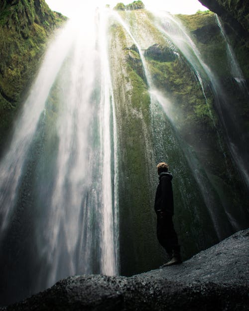 Free Person Standing Beside Waterfalls Stock Photo