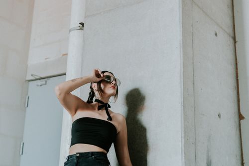 Free Confident woman poses against a modern urban wall in Guadalajara, Mexico. Stock Photo