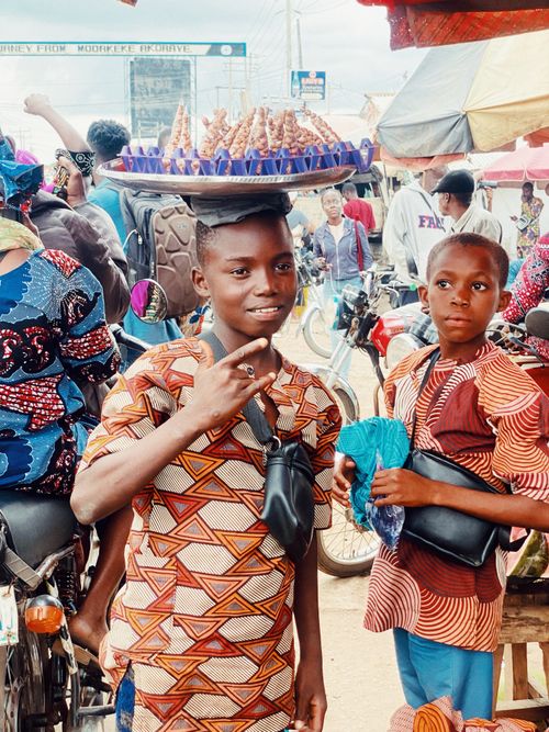 Free Colorful street scene with children in traditional attire at Ife market, Nigeria. Stock Photo