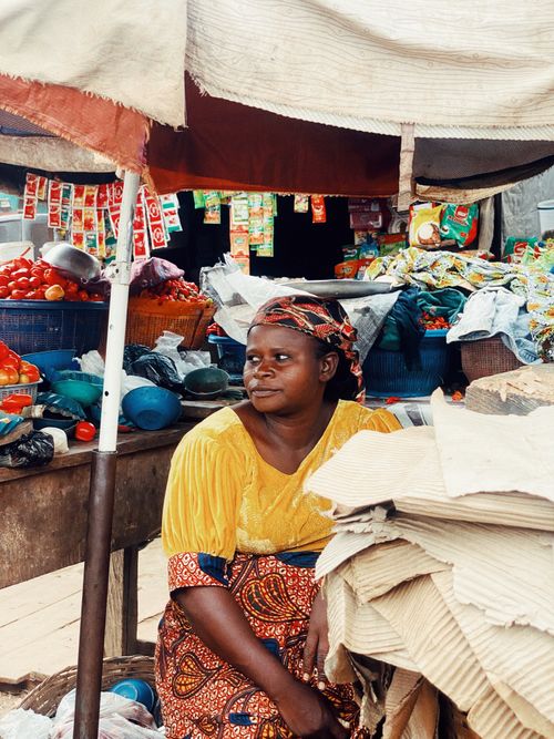 Free A woman at a vibrant outdoor market stall in Ife, Nigeria, showcasing local produce and goods. Stock Photo