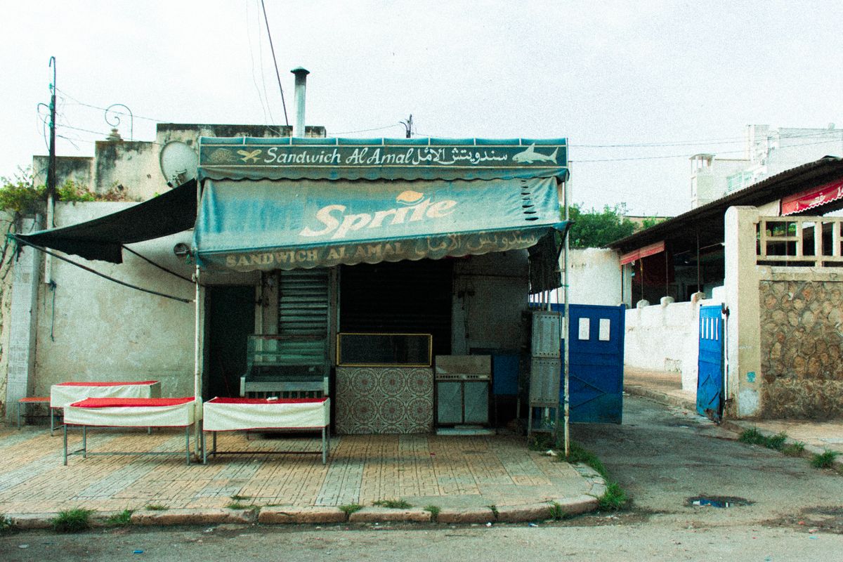 Stock photo of an older storefront with a faded, weathered awning