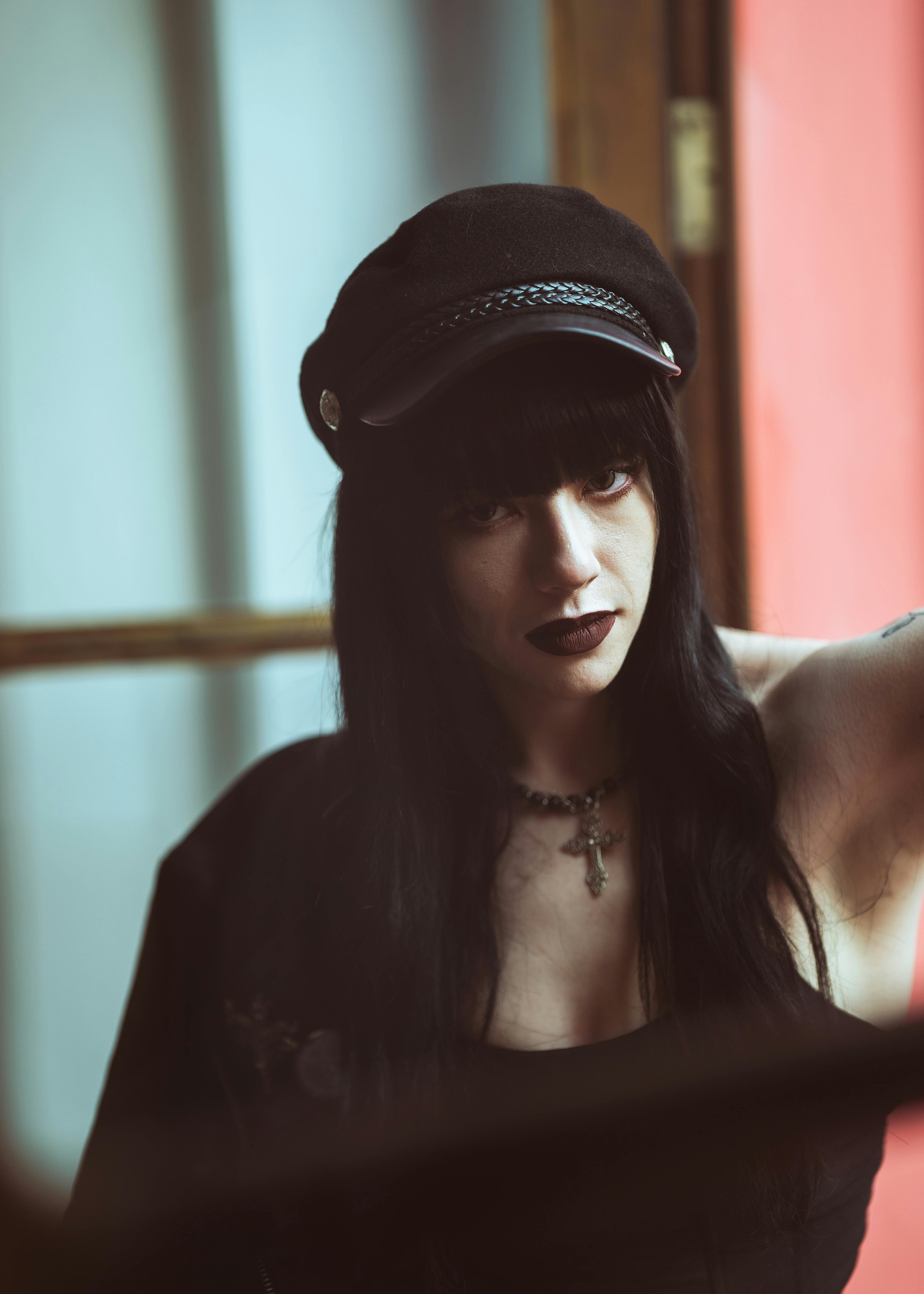 a woman with black hair and a hat