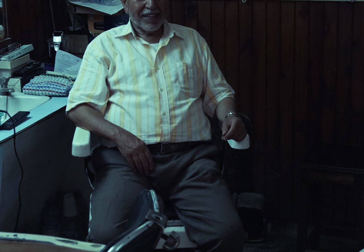 A man sitting in a barber chair