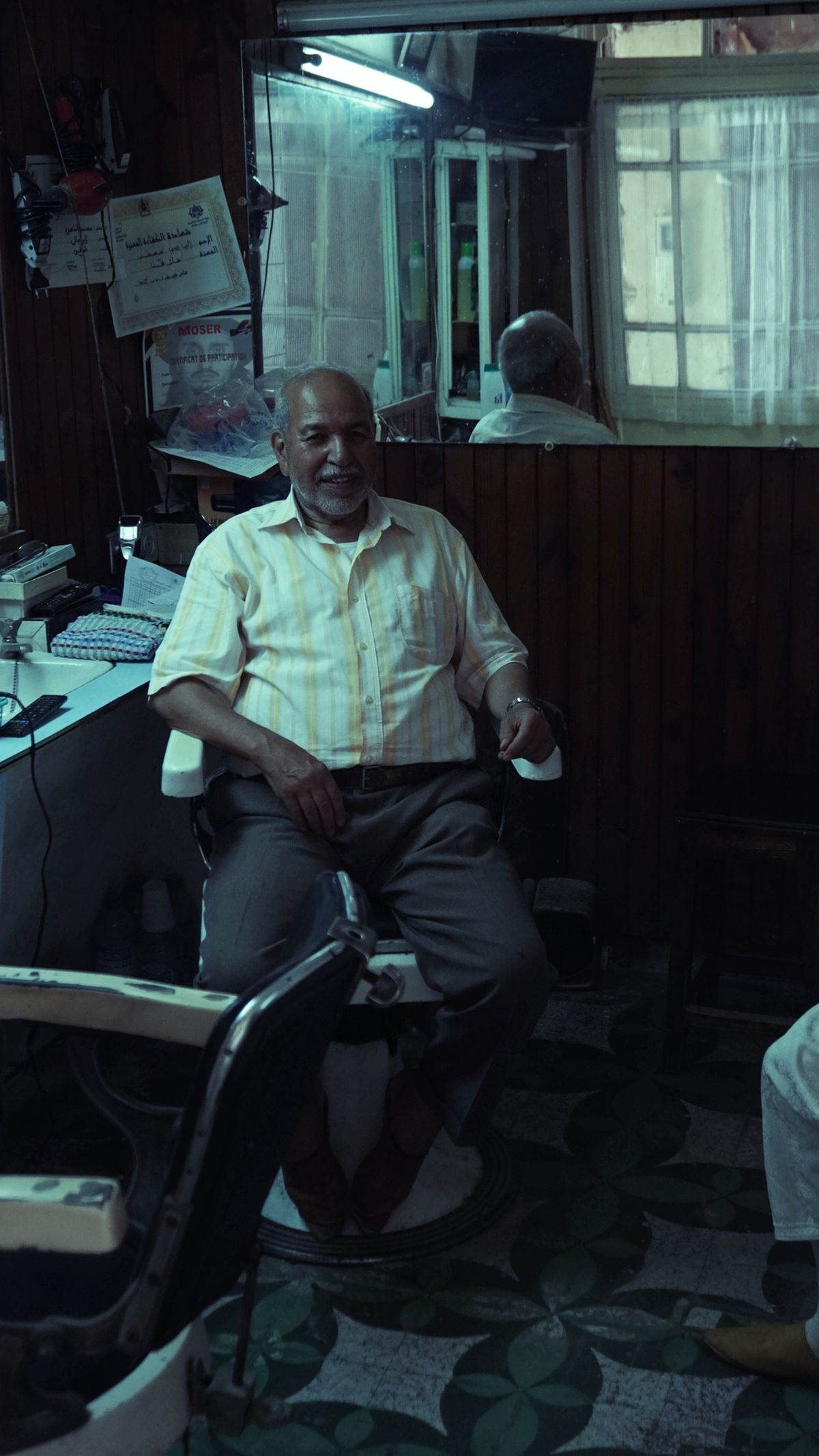 A man sitting in a barber chair