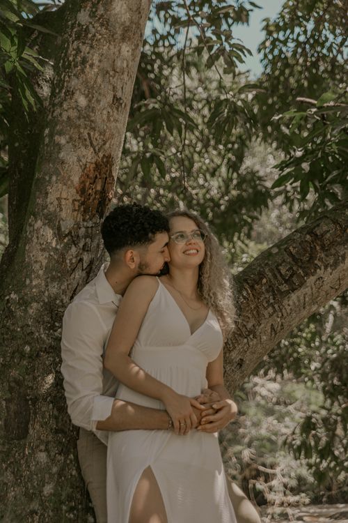 Romantic Couple Embracing Under Tree Canopy · Free Stock Photo