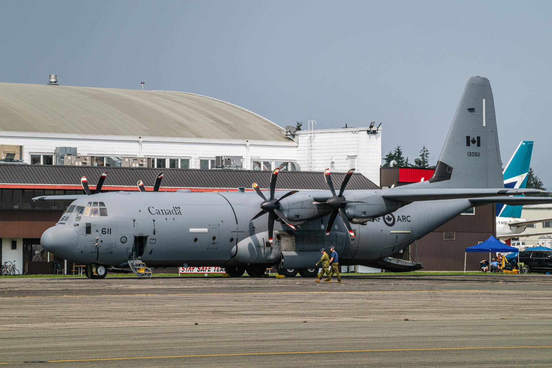 A large military plane sitting on top of a runway