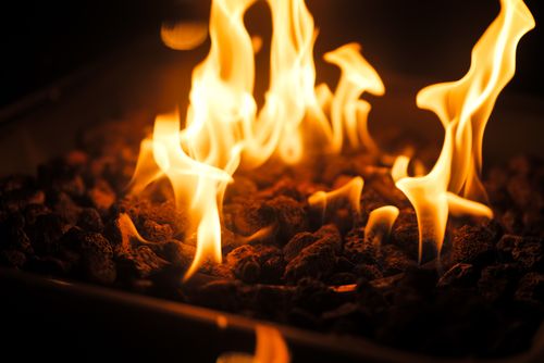 Free Bright flames dance over charcoal in a firepit, offering warmth and light. Stock Photo