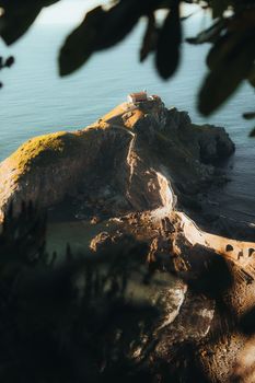Scenic aerial photo capturing the captivating sunset view of San Juan de Gaztelugatxe along the rugged coastline.