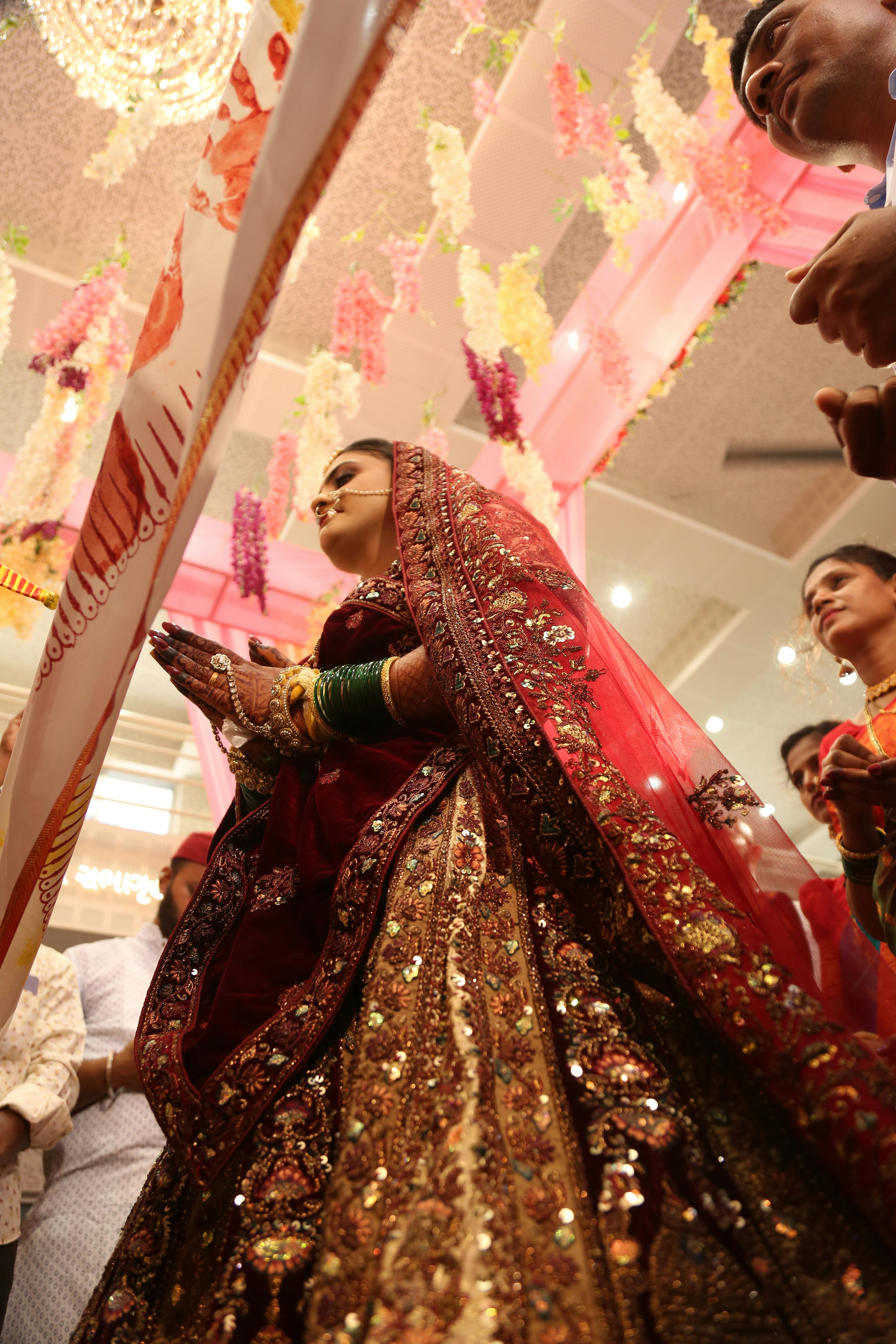 A bride in a red and gold wedding dress · Free Stock Photo