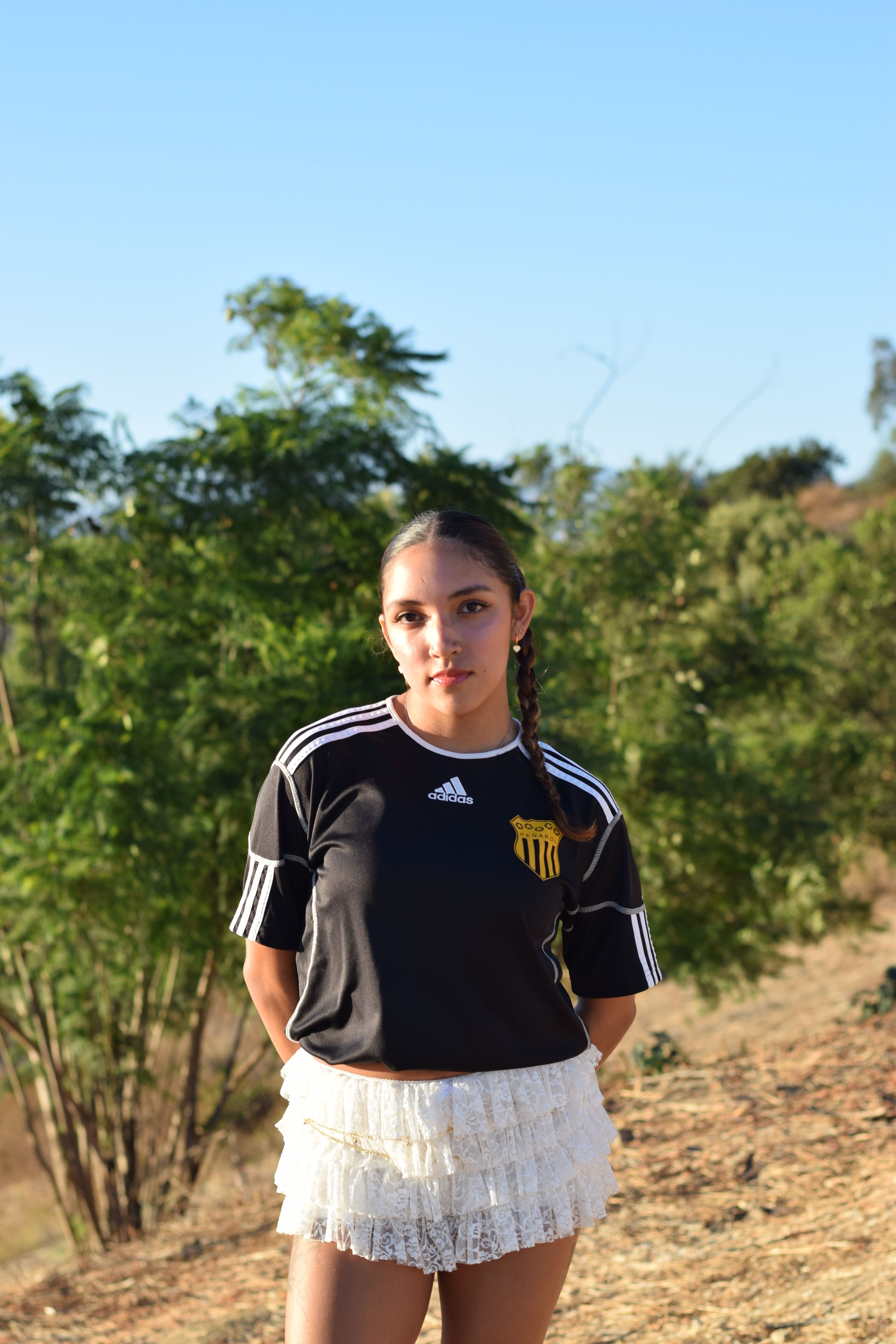 Adolescent girl standing outdoors in nature enjoying a sunny day in Los Angeles.
