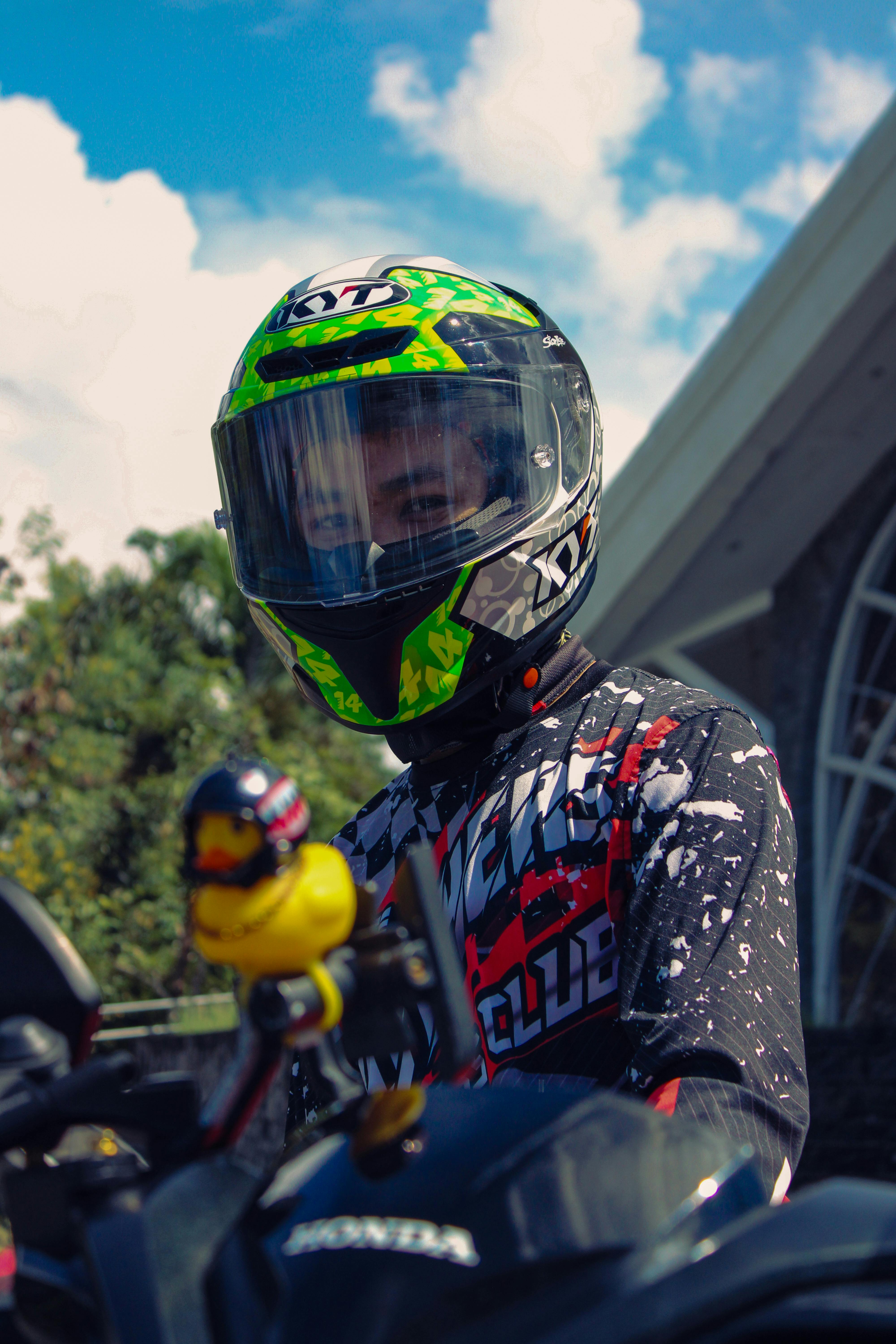 A biker in full gear prepares to race on an outdoor track.