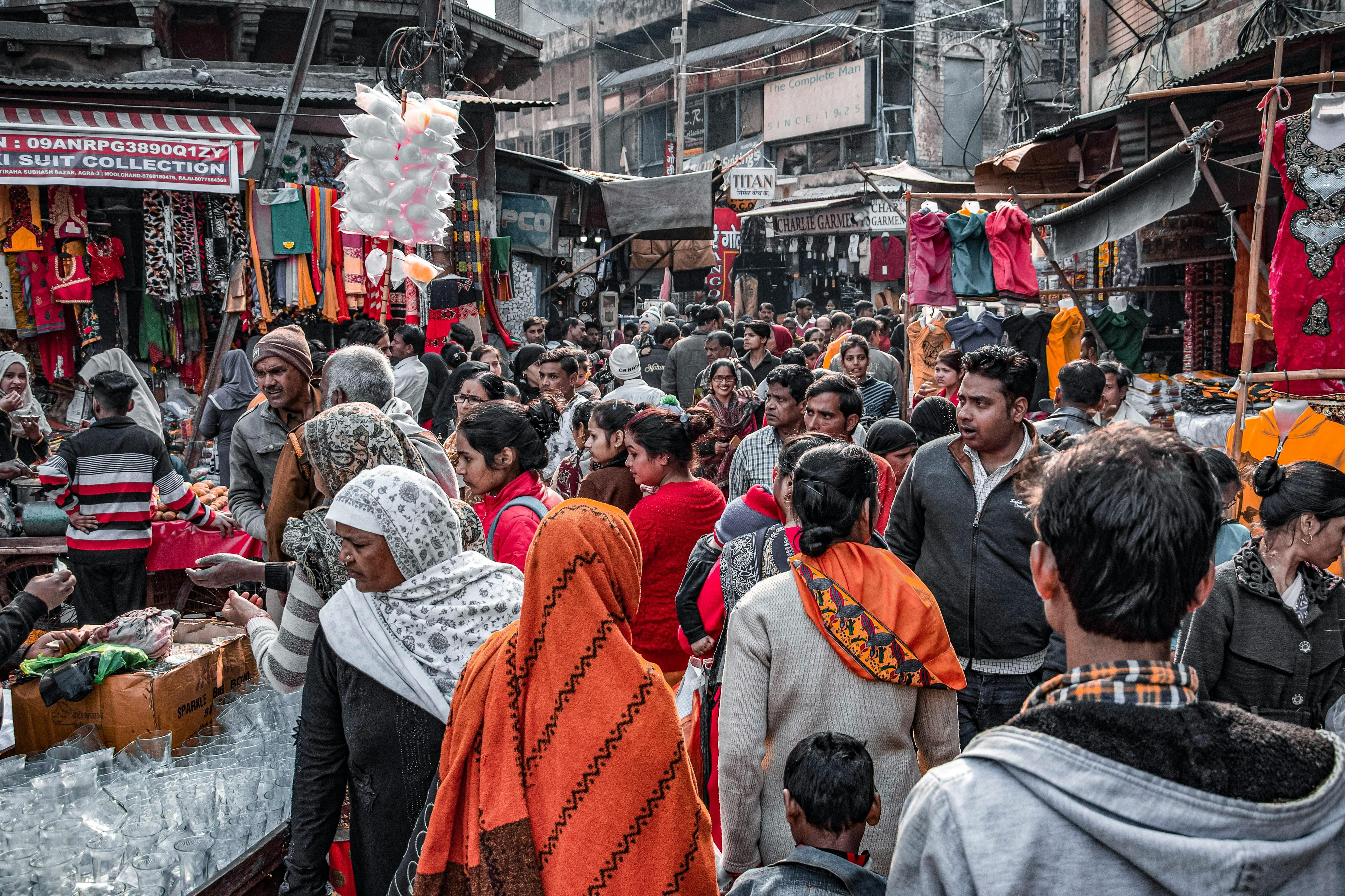 a crowded market with people walking around