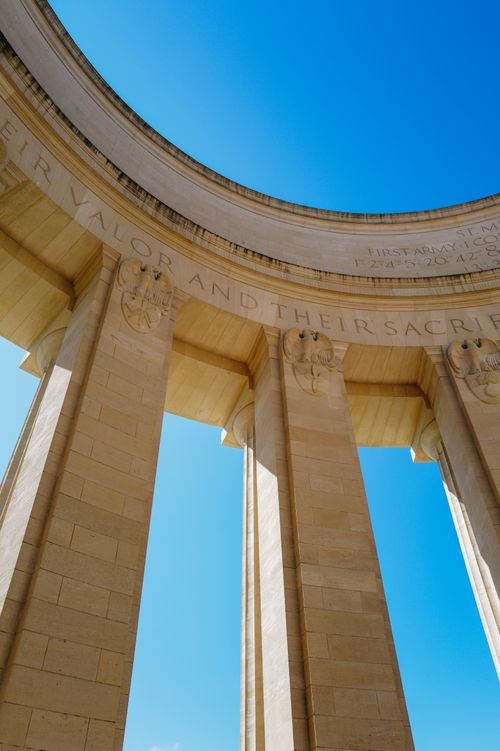 Free View of neoclassical monument columns under a clear blue sky, showcasing historical architecture. Stock Photo