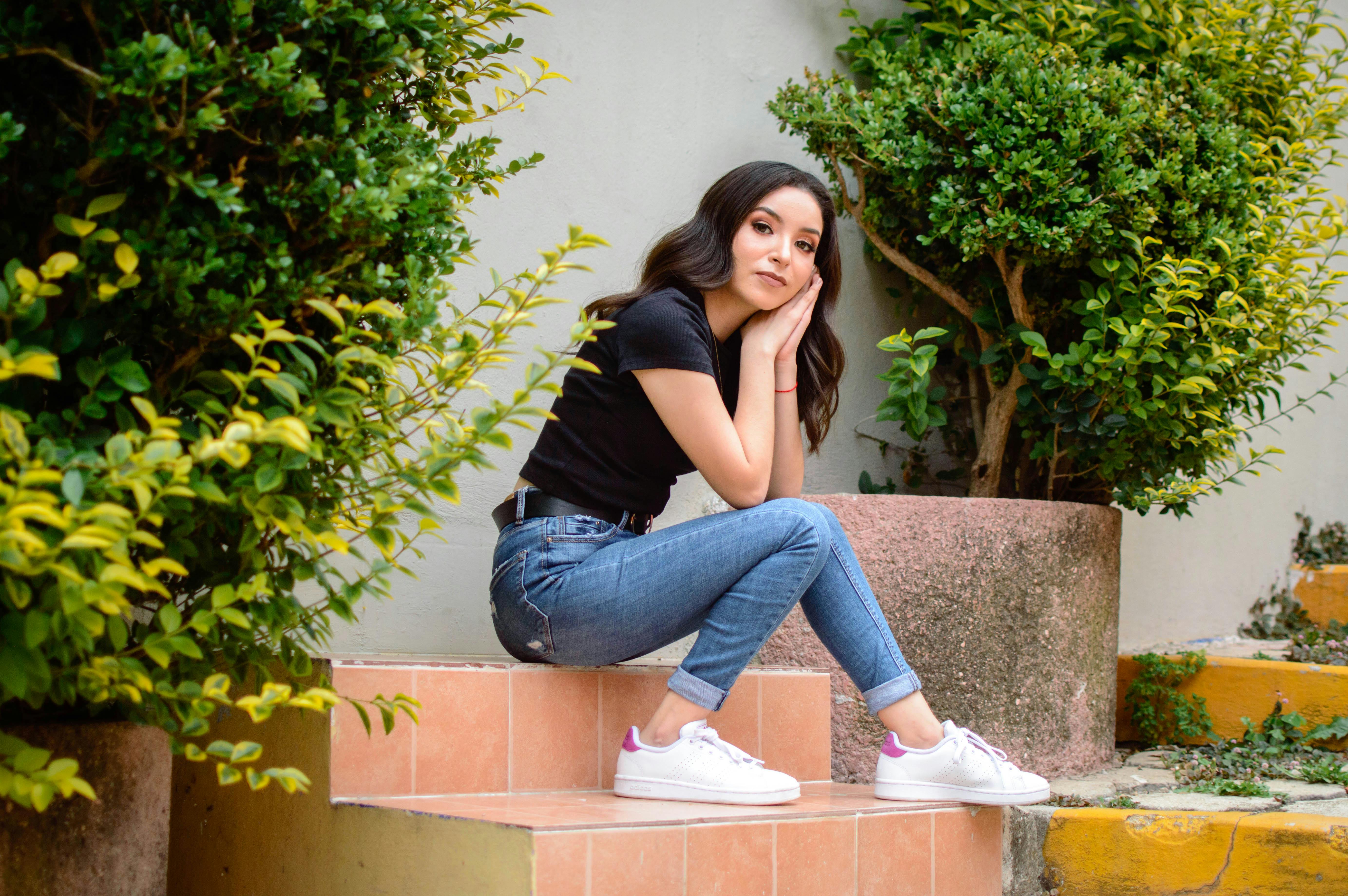 a woman sitting on some steps with her feet up