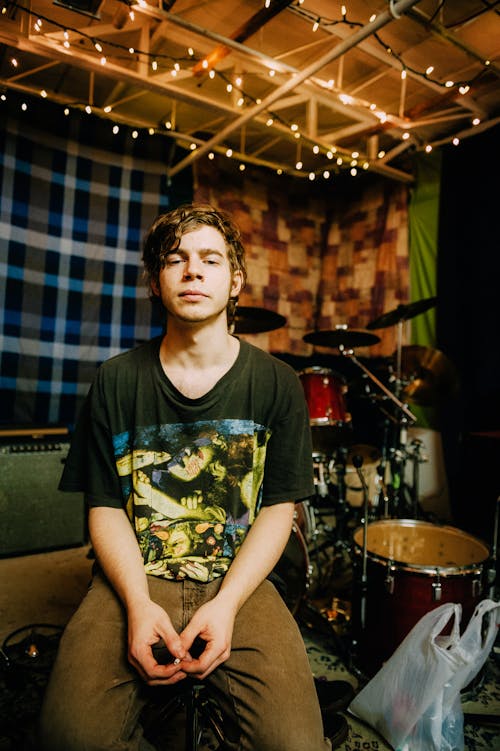 Man Sitting Beside Drum Set