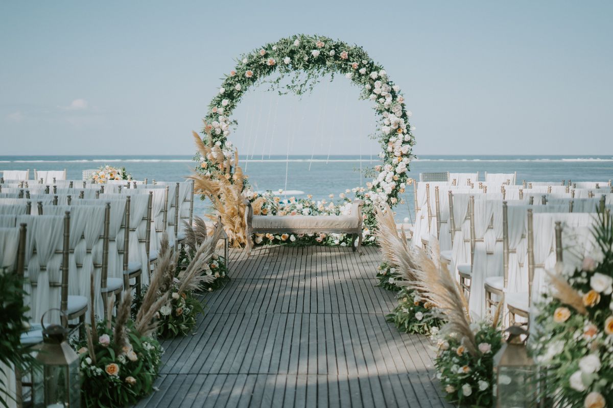 Baby shower photo booth ideas with a floral arch frame dressed with white and blush flowers