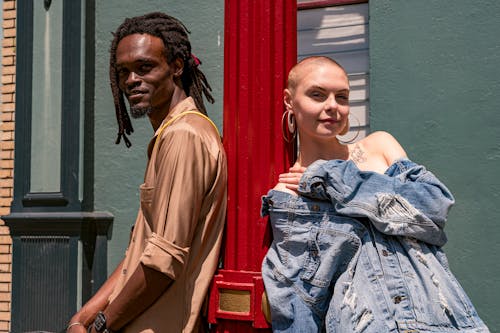 Woman and Man Leaning on Post