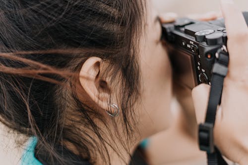 Close-Up Photo Of Woman Holding A Camera