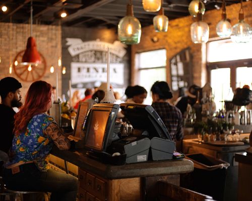 Group of people working and socializing at the cafe