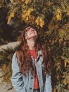 Woman Standing Under Yellow Leaf Tree