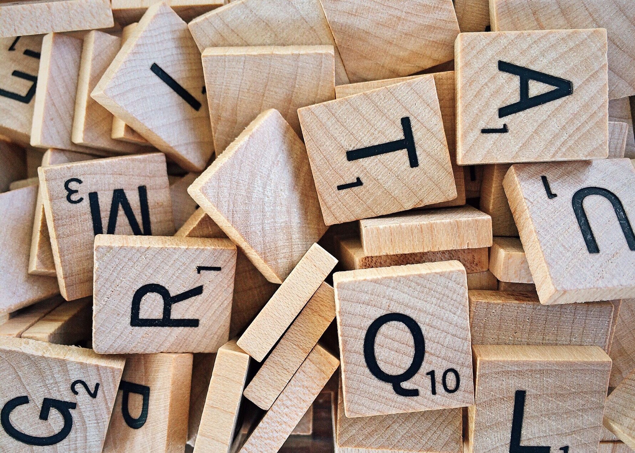 Scrabble letter tiles spelling out words on a wooden board