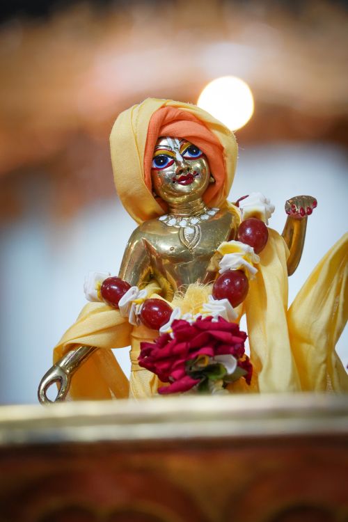 Free Close-up of a decorative golden statue adorned with vibrant fruits and flowers, symbolizing cultural richness. Stock Photo