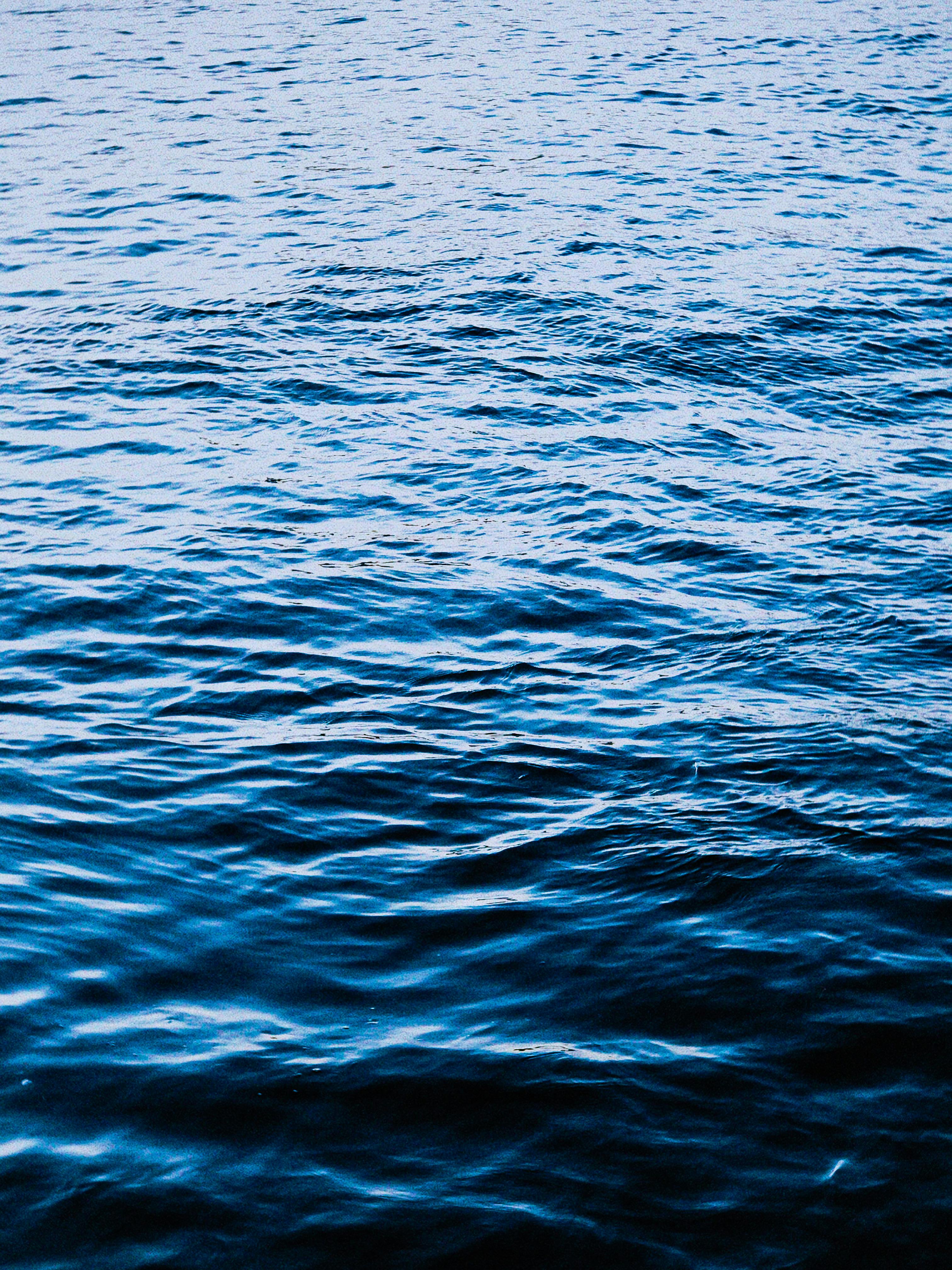 Peaceful blue ocean waves creating a serene, textured water surface.