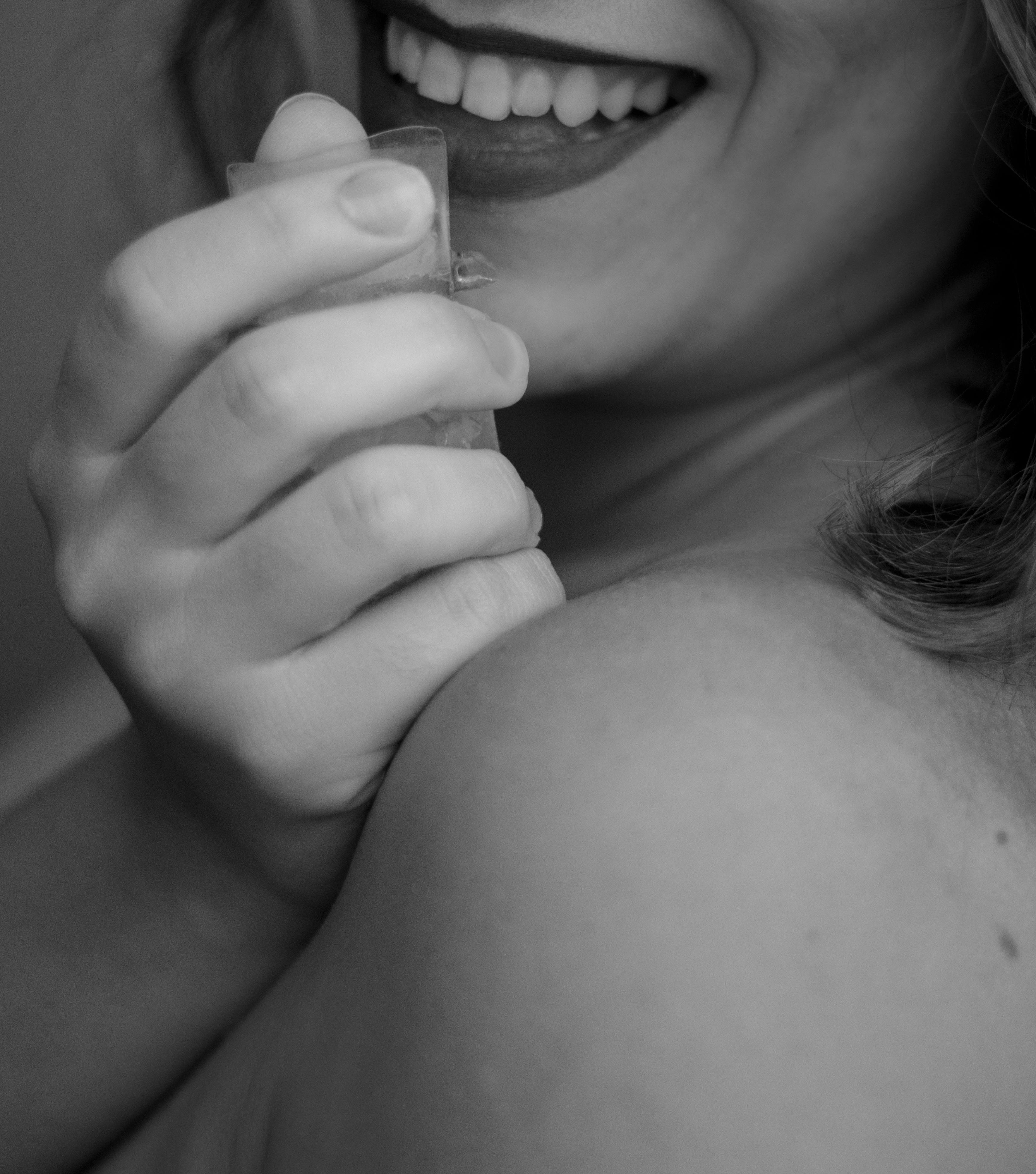 a woman is smiling while holding a toothbrush