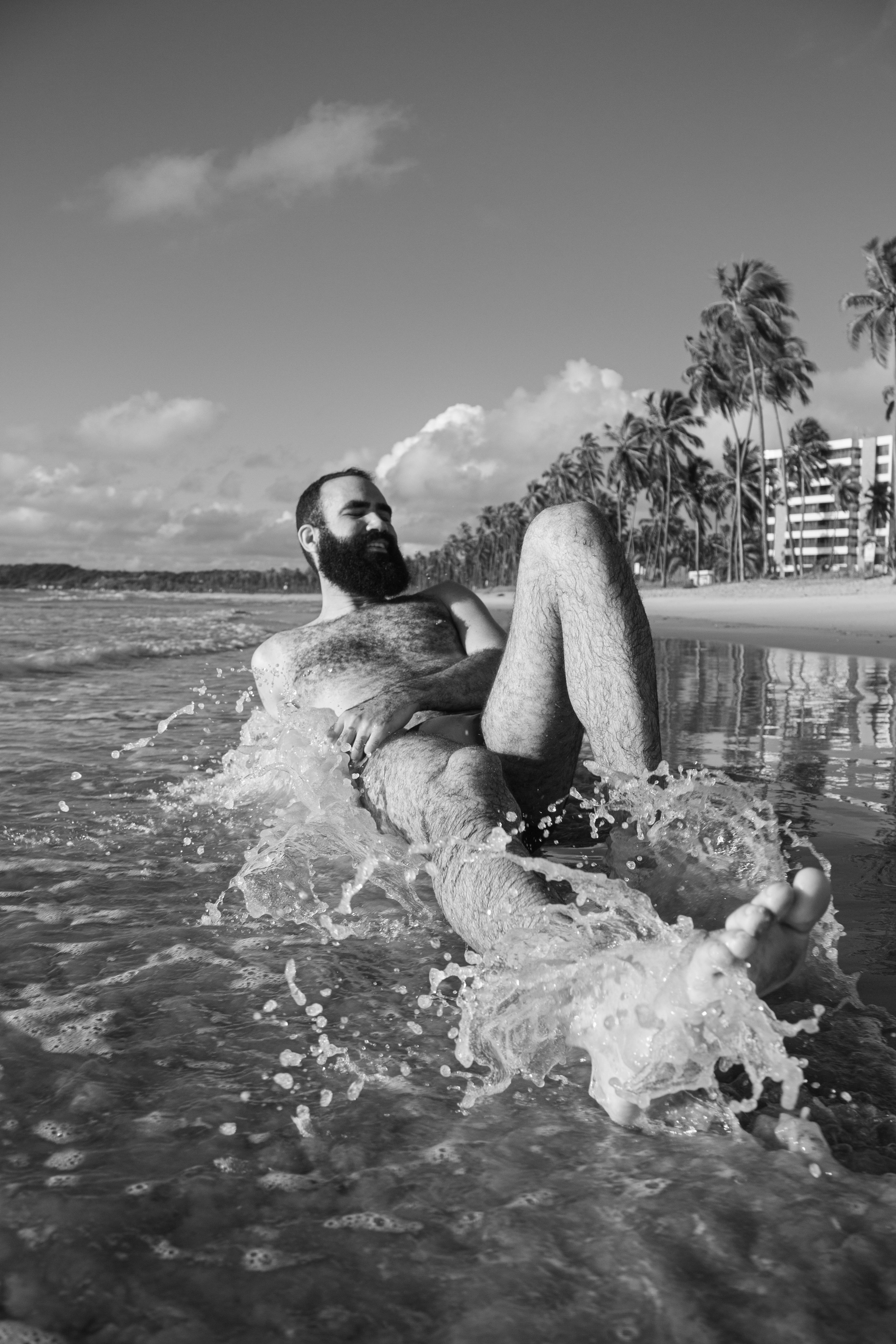 a man with a beard is laying in the water