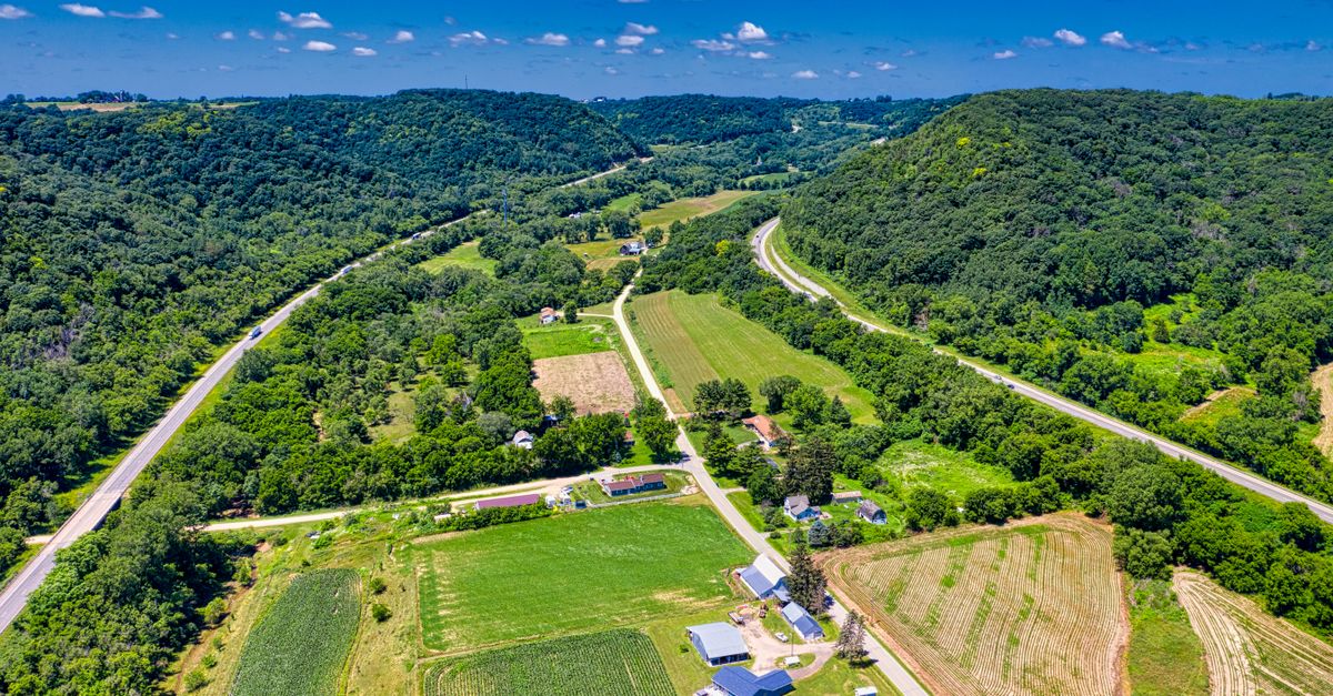 Stunning aerial view of lush farmland and rolling hills in Dakota, Minnesota during summer.