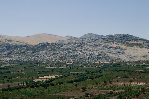 Free Explore the lush, rolling landscape of Çermik, Diyarbakır with verdant fields and majestic mountains. Stock Photo
