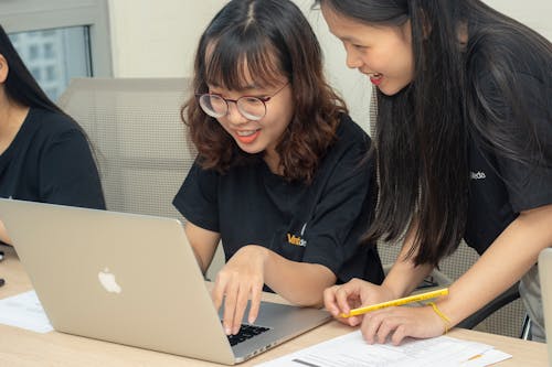 Photo Of Women Looking In The Laptop