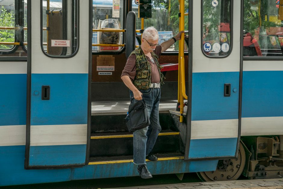 Smartphone screen showing the Jakdojade public transport app with a route in Warsaw, Poland
