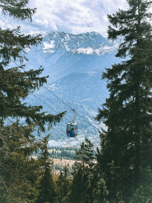 Free Winter cable car ride in Garmisch-Partenkirchen offers stunning views of the snowy Bavarian Alps. Stock Photo